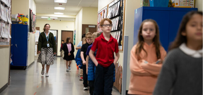 Children and Teacher in the hallway.